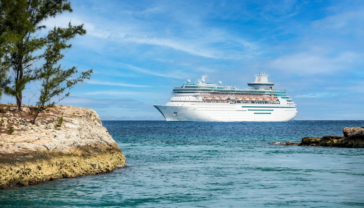 Cruise ship in Caribbean sea with island on foreground